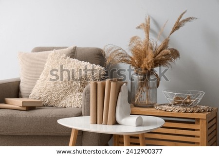 Holder with books on table in living room