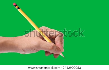 Holding pencil on green screen 