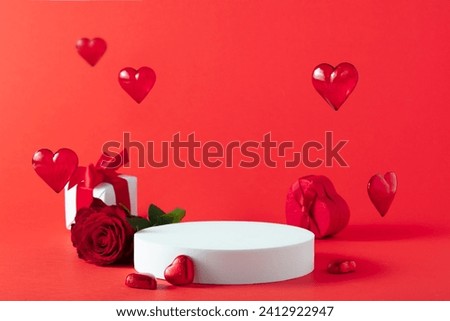 Abstract empty white podium, hearts and rose flowers on red background. Mock up stand for product presentation. 3D Render. St valentines day promotion concept. Royalty-Free Stock Photo #2412922947