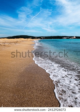 View to a beach, sea and cloudy sky