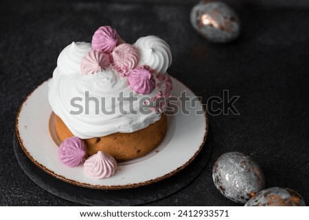 Beautiful stylish still life. Easter cake with meringue, marshmallows, and Easter eggs on a dark background. happy Easter 2024.