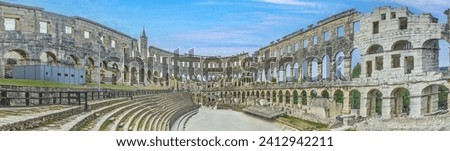 View inside the Roman amphitheater in the Croatian city of Pula without people during the day Royalty-Free Stock Photo #2412942211