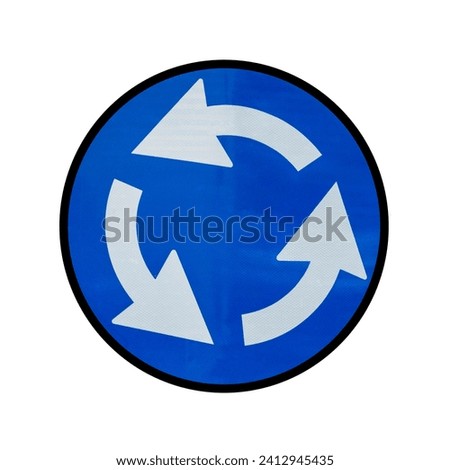  A Roundabout traffic sign, indicating entry into a roundabout. A symbol of smooth traffic flow, it promotes road safety and the need to follow rules in heavily trafficked intersections. Royalty-Free Stock Photo #2412945435