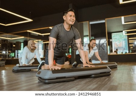 male instructor training his trainee fitness and muscle workout Royalty-Free Stock Photo #2412946851