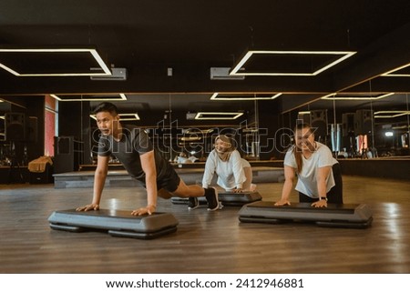 sporty people doing fitness in gym for weight loss program Royalty-Free Stock Photo #2412946881