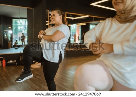 asian sporty women practising fitness indoor, sports activity concept Royalty-Free Stock Photo #2412947069