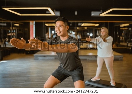 sporty professional coach training fitness class at indoor gym Royalty-Free Stock Photo #2412947231