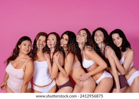 Women of different shapes in undergarments embracing body positivity.  Royalty-Free Stock Photo #2412956875