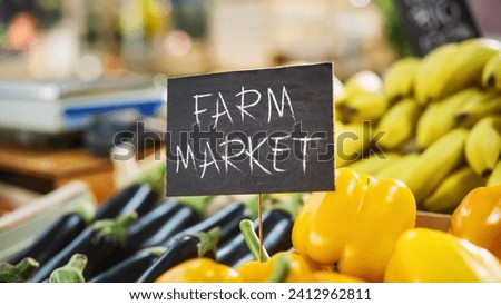Farm Market Sign on a Food Stall with a Selection of Fresh Organic Fruits and Vegetables from a Local Farmland. Outdoors Marketplace with Sweet Bell Peppers, Ripe Eggplants, Eco-Friendly Bananas
