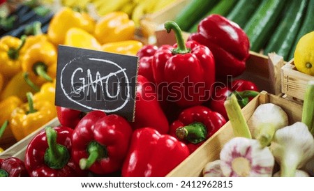 No GMO Sign on a Farmers Market Food Stall with Fresh Organic Red Bell Peppers from a Local Farmland. Outdoors Marketplace with Eco-Friendly Fruits and Vegetables Without Genetical Modifications