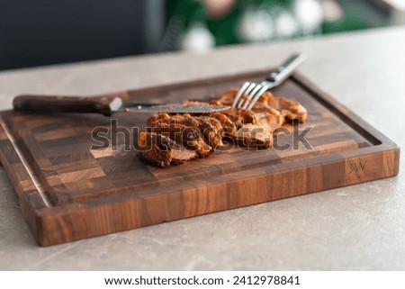 Grilled pork steak slices on a wooden cutting board. High quality photo