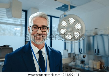 Portrait of pharmaceutical sales representative in medical building, waiting for doctor, presenting new pharmaceutical product. Hospital director, manger in private medical clinic. Royalty-Free Stock Photo #2412994441