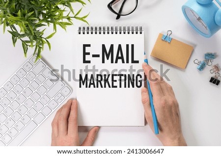 E-mail marketing and Hands. E-mail marketing Written on white paper with keyboard , calculator, glasses, felt pens on white background.