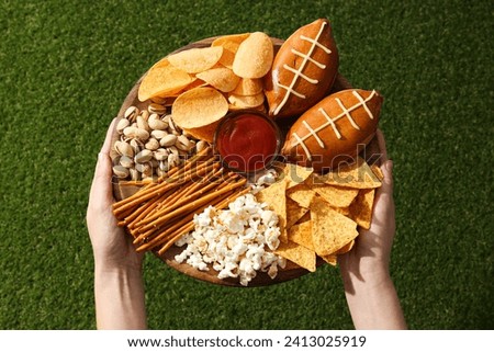 A bowl with various beer snacks on the grass