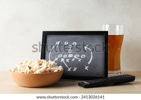 Black board with game strategy and a bowl of popcorn Royalty-Free Stock Photo #2413026141