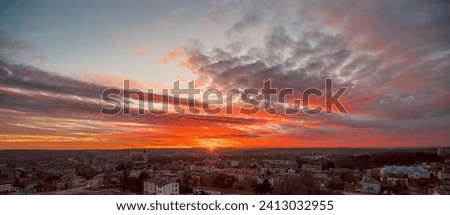 An extremely spectacular colorful sunset over the city (Ostrowiec).The setting sun "painted" a beautiful slightly abstract colorful picture on the cloudy sky - a work of nature s art .