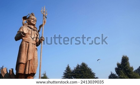 old statue of god shiv holding trishul Royalty-Free Stock Photo #2413039035