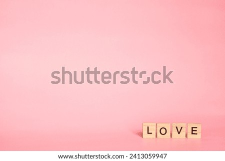 Postcard Valentines Day concept with empty copy space. Letters of the English alphabet folded into the word love. soft pastel delicate mat mistyrose pink background. 14th of February Royalty-Free Stock Photo #2413059947