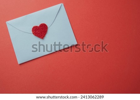 White card with a heart closeup on a red background with copy space.