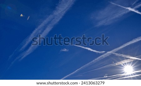Nitrogen oxides (NOx), vapour trails  after airplanes in the sky, air pollution. Royalty-Free Stock Photo #2413063279