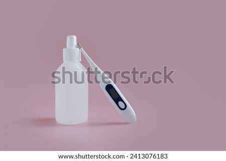 white medical jar with a thermometer on a pink background. medical drug. treatment with medications.