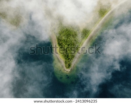Cloudy island in the volcanic lake