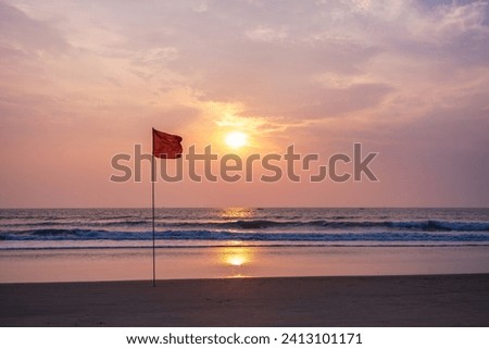 red flag on beach on sea or ocean as a symbol of danger. The sea state is considered dangerous and swimming is prohibited.