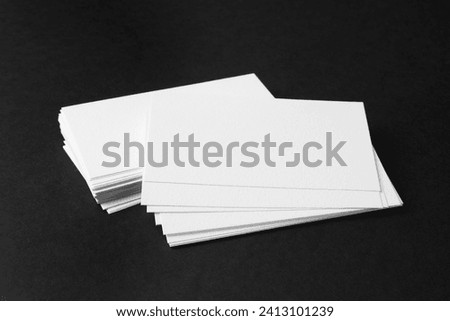 Blank business cards on black background. Mockup for design