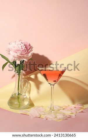 Modern still life with pink martini, alcoholic cocktail and peony flowers on elegant modern background, minimal concept for bar and holiday party, cafe, advertising banner, selective focus, 