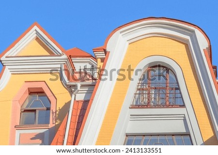 It is view of facade of colorful apartment building. It is multicolored view of buildings. It is a close up view of facades in sunny day.