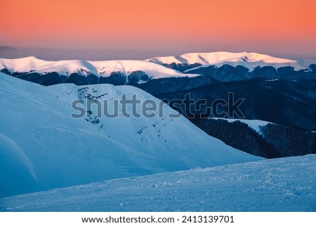 Breathtaking sunset over snow-capped mountains. Location Carpathian national park, Svydovets mountain range, Ukraine, Europe. Aki resort Dragobrat. Photo wallpapers. Discover the beauty of earth.