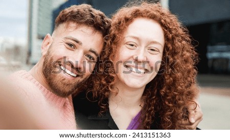 Happy ginger hair brother and sister having fun taking selfie picture outdoor. Family travel vacation concept