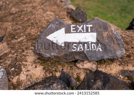 arrow painted on stone with white paint