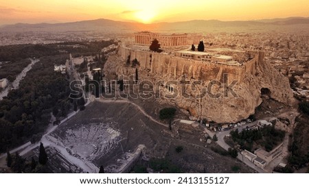 Aerial drone photo of iconic Acropolis hill, the unique masterpiece of Ancient world the Parthenon and theatre of Dionysus at sunset, Athens historic centre, Attica, Greece