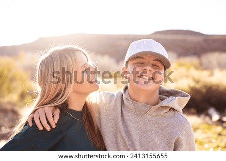 Mother playing with her cute teenage son. Having a happy moment together. Concept photo about parenting tough teenage children. Candid photo Royalty-Free Stock Photo #2413155655