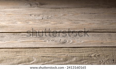 Close-up of weathered, rustic pine boards forming a gradient background, perfect for enhancing the texture of design projects and creative compositions.
