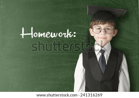 Cheerful little boy on blackboard. Looking at camera. School concept