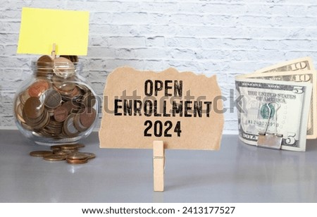 open enrollment 2024. text on a sticker next to money and banknotes.