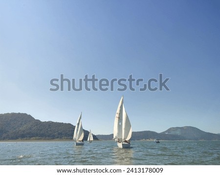 sailing a sailboat on a high altitude lake in the forests and mountains of southern Mexico. Royalty-Free Stock Photo #2413178009