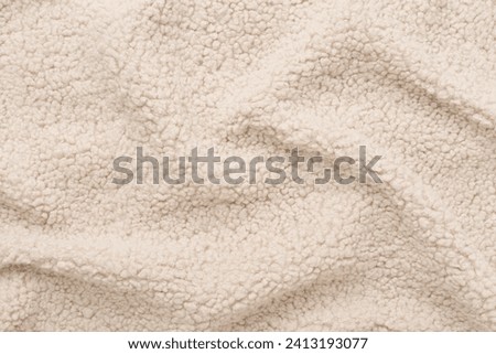 Beige cuddle teddy bear fabric as background, top view Royalty-Free Stock Photo #2413193077