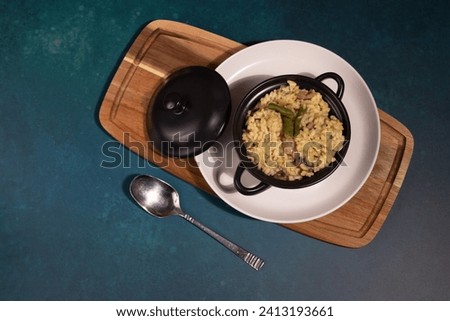 Flat lay image of rissotto served in a mini casserole dish 