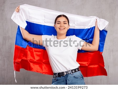 Portrait of positive young woman with the flag of Russia