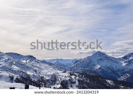 Stunning view from Sauze D'Oulx ski resort, Turin, Italy. Beautiful Italian alpine peaks of snow capped mountains in the Piedmont region.