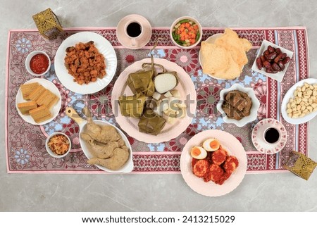 Top View Ketupat Lebaran Menu, Indonesian Celebratory Dish of Rice Cake with Various Side Dishes, Popular Served During Eid Celebrations. Royalty-Free Stock Photo #2413215029