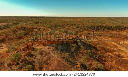 A mesa rock formation with small caves in its escarpments locally known as "Cave Hill" in the Australian outback Royalty-Free Stock Photo #2413224979