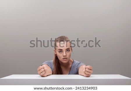 With clenched fists and intense gaze, the woman's fury is almost palpable, a tempest brewing Royalty-Free Stock Photo #2413234903