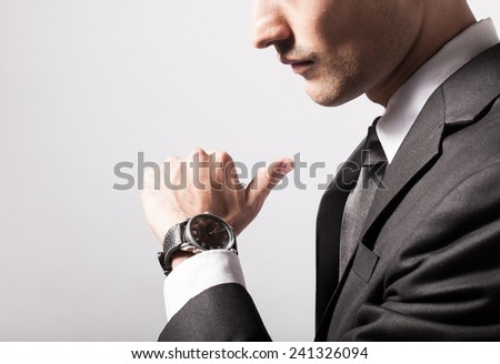 Man checking the time on his wrist watch