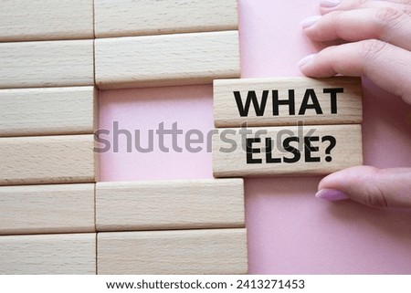 What else symbol. Concept word What else on wooden blocks. Businessman hand. Beautiful pink background. Business and What else concept. Copy space