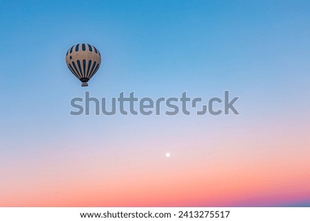 hot air balloon against beautiful sky and moon in the backdrop
