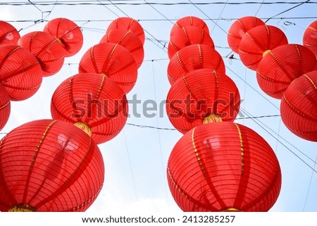 Low angle of red lanterns with sky on the background